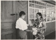 Х. Байрамукова у дверей своего дома с сыном Арсеном.jpg